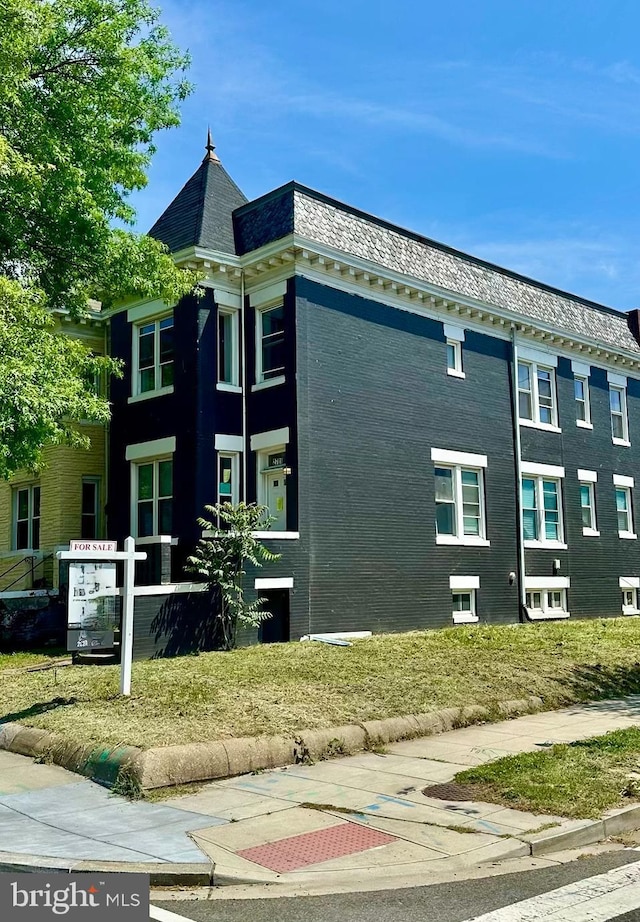 view of side of home featuring brick siding