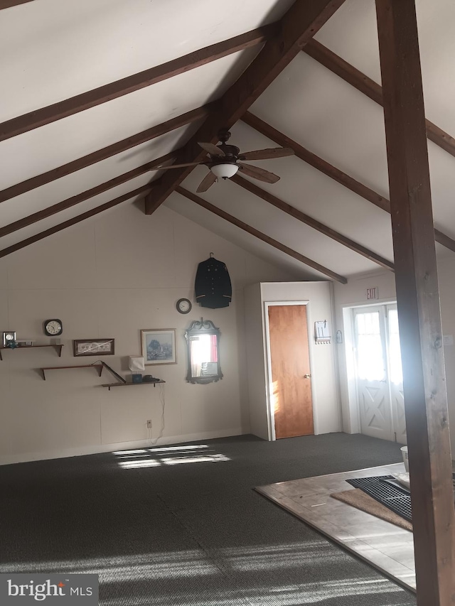 living room featuring ceiling fan, lofted ceiling with beams, and carpet flooring