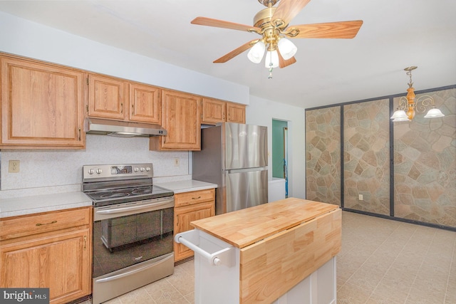kitchen with ceiling fan, hanging light fixtures, wooden counters, stainless steel appliances, and under cabinet range hood