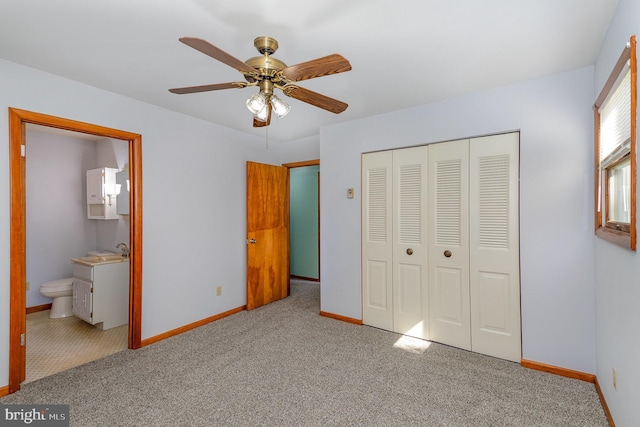 unfurnished bedroom with baseboards, carpet, and a closet