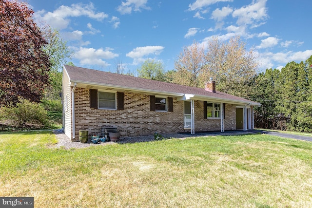 single story home with brick siding, a front lawn, and a chimney