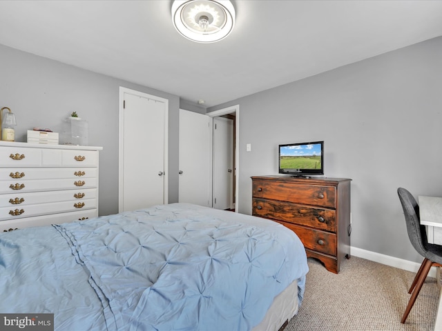 bedroom with baseboards and light colored carpet