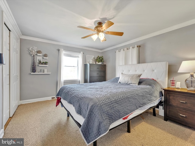 bedroom with a ceiling fan, light colored carpet, baseboards, a closet, and ornamental molding
