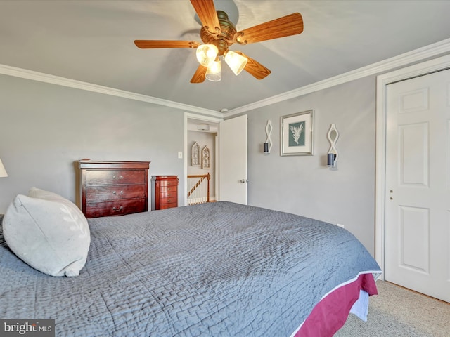 carpeted bedroom with crown molding and ceiling fan