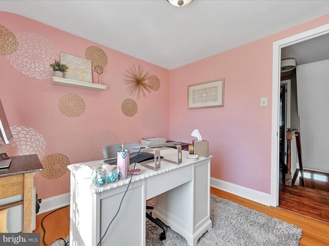home office featuring baseboards and light wood-style flooring