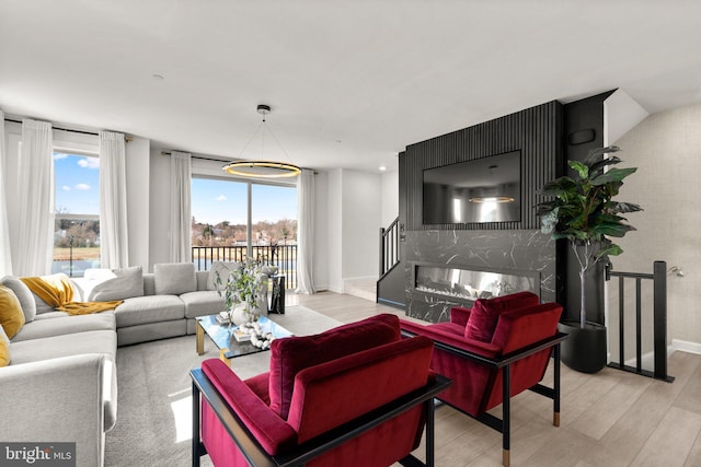 living area with baseboards and wood finished floors