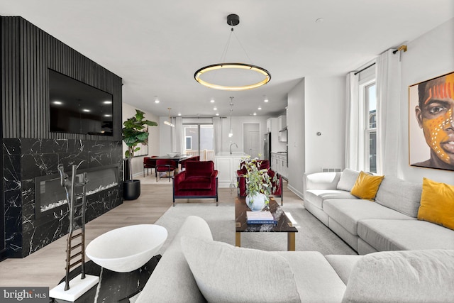 living room featuring baseboards, visible vents, and light wood-style flooring