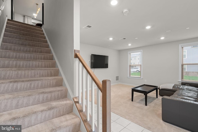 staircase with recessed lighting, carpet, tile patterned flooring, and visible vents
