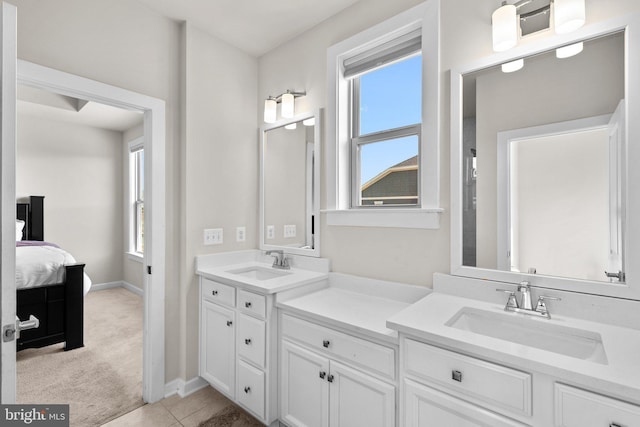 ensuite bathroom featuring plenty of natural light, a sink, and ensuite bathroom