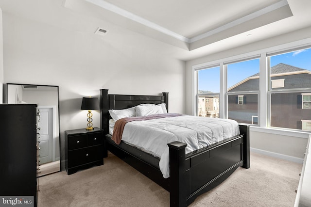 bedroom featuring visible vents, ornamental molding, light carpet, baseboards, and a raised ceiling