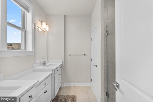 full bathroom with vanity, tile patterned floors, and a tile shower