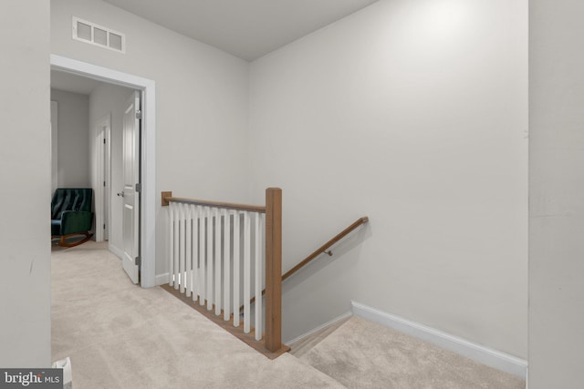 stairs featuring visible vents, baseboards, and carpet floors