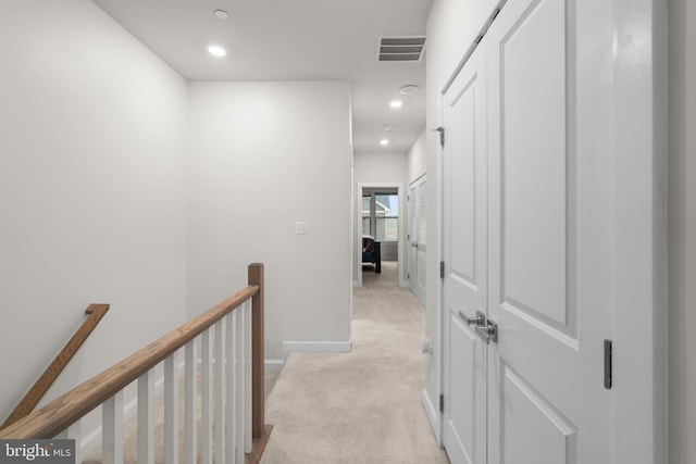 hall featuring visible vents, light carpet, recessed lighting, and an upstairs landing