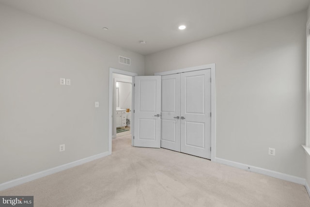 unfurnished bedroom featuring baseboards, light carpet, recessed lighting, and visible vents
