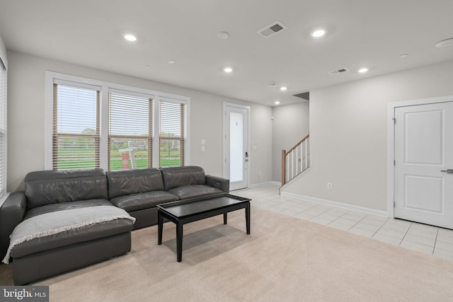 living area featuring visible vents, stairs, light tile patterned flooring, light carpet, and recessed lighting