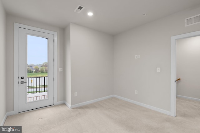 doorway to outside with baseboards, carpet, and visible vents