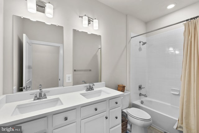 bathroom with a sink, toilet, double vanity, and shower / tub combo with curtain