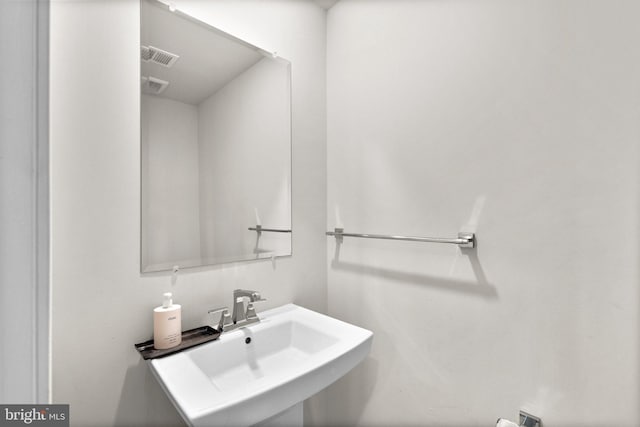 bathroom with visible vents and a sink