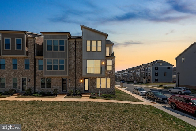 townhome / multi-family property featuring a yard and a residential view