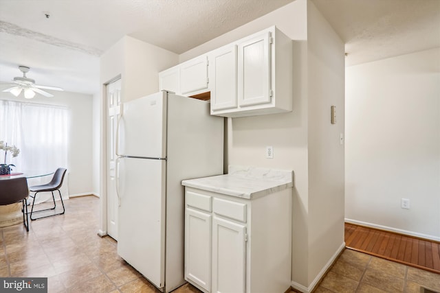 3203 Forest Run Dr, District Heights, MD 20747 - kitchen featuring freestanding refrigerator, white cabinetry, baseboards, ceiling fan, and light countertops