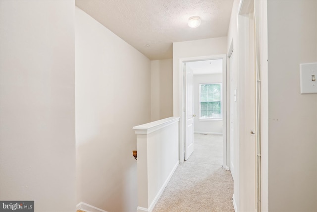 3203 Forest Run Dr, District Heights, MD 20747 - hall with a textured ceiling, light carpet, an upstairs landing, and baseboards