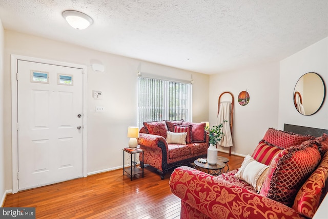 3203 Forest Run Dr, District Heights, MD 20747 - living area with a textured ceiling, baseboards, and hardwood / wood-style flooring