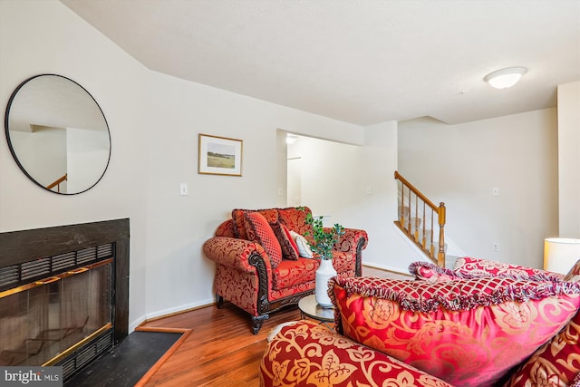 3203 Forest Run Dr, District Heights, MD 20747 - living room with stairway, wood finished floors, baseboards, and a fireplace with flush hearth