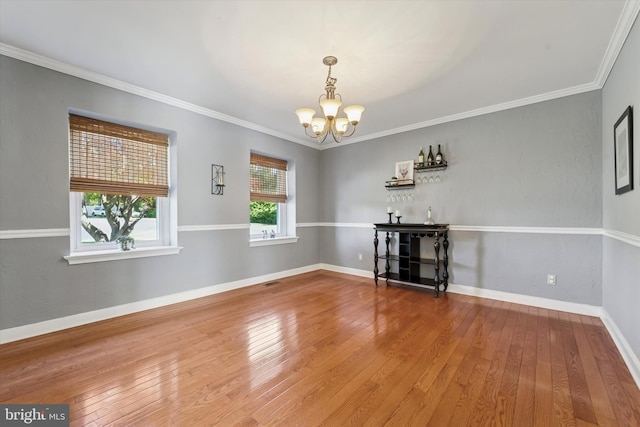 380 Bishop Hollow Rd, Newtown Square, PA 19073 - unfurnished living room featuring a chandelier, hardwood / wood-style floors, crown molding, and baseboards