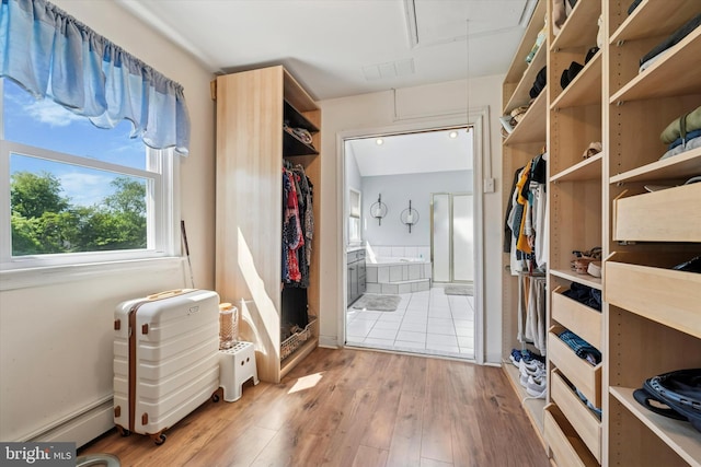 380 Bishop Hollow Rd, Newtown Square, PA 19073 - walk in closet with attic access, baseboard heating, and light wood-type flooring
