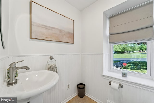 380 Bishop Hollow Rd, Newtown Square, PA 19073 - bathroom featuring a sink, a wainscoted wall, and tile patterned flooring