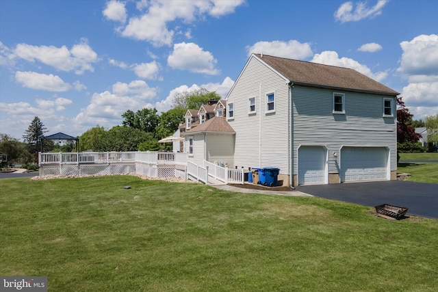 380 Bishop Hollow Rd, Newtown Square, PA 19073 - view of home's exterior with a garage, asphalt driveway, a deck, and a lawn