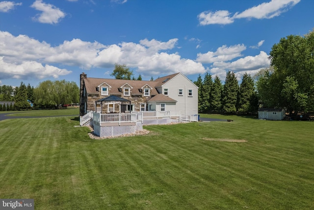 380 Bishop Hollow Rd, Newtown Square, PA 19073 - rear view of house with a wooden deck, a storage shed, a lawn, and an outdoor structure