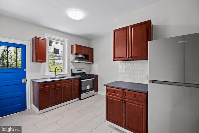 kitchen with a sink, appliances with stainless steel finishes, dark brown cabinets, and range hood