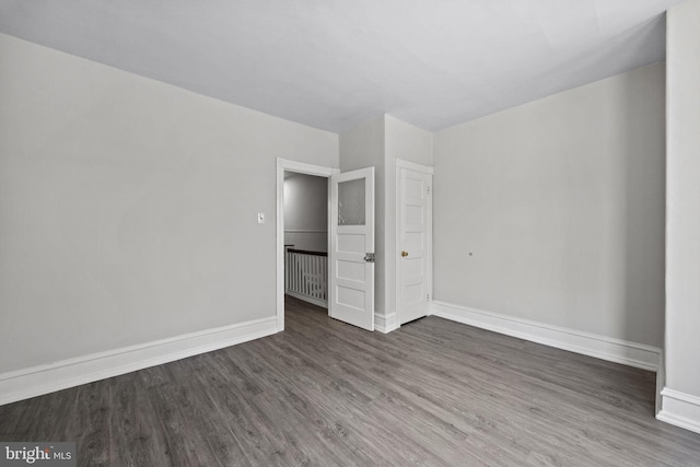 unfurnished bedroom featuring baseboards and wood finished floors
