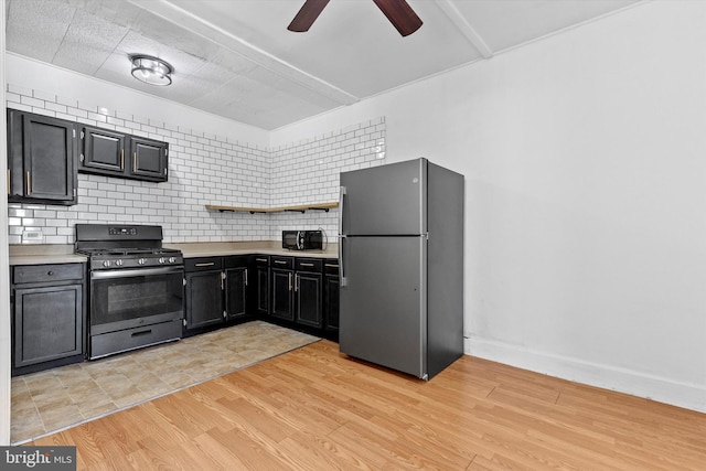 kitchen featuring light countertops, stainless steel appliances, ceiling fan, and decorative backsplash