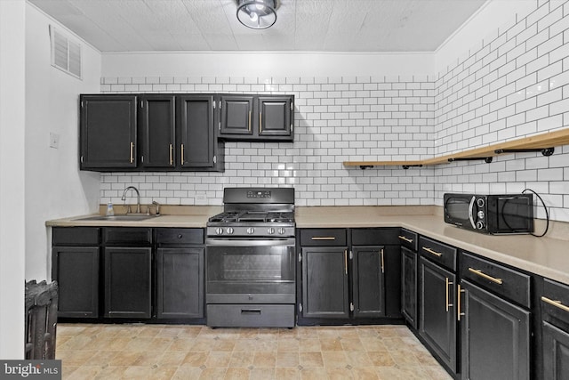 kitchen with open shelves, a sink, visible vents, light countertops, and gas range oven