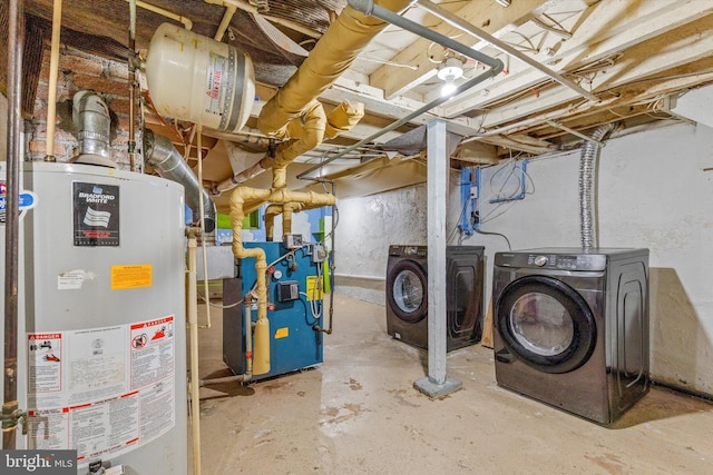 unfinished below grade area featuring gas water heater and washing machine and clothes dryer