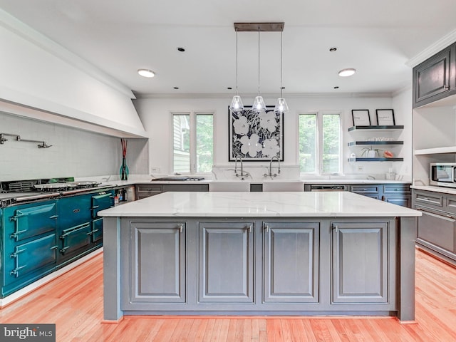 kitchen with stainless steel microwave, a center island, decorative backsplash, ornamental molding, and gas cooktop