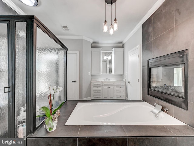 bathroom with ornamental molding, a shower stall, a bath, and vanity