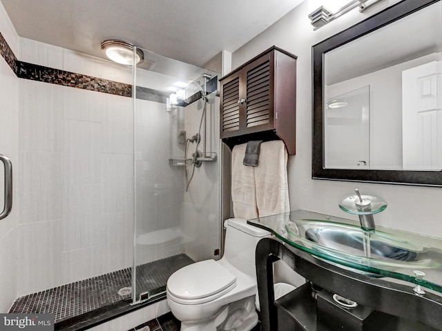 full bath featuring toilet and a stall shower