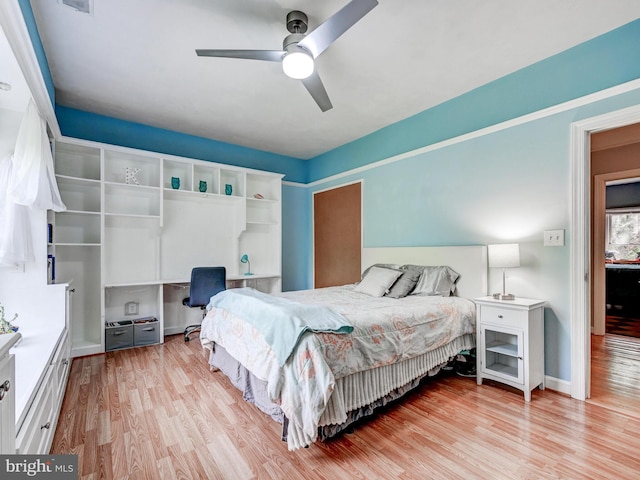 bedroom with light wood-style floors, ceiling fan, and baseboards