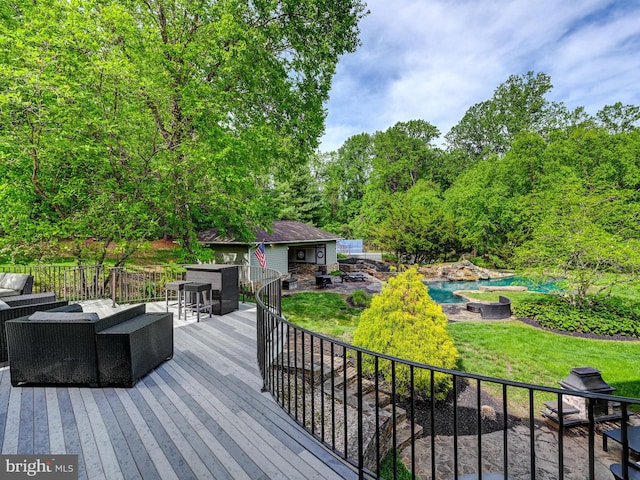 wooden terrace with an outdoor living space, a swimming pool, a lawn, and an outdoor structure