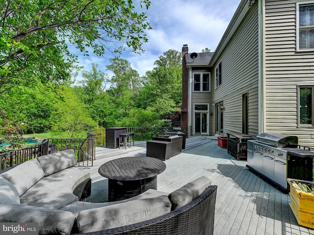 wooden terrace featuring outdoor lounge area