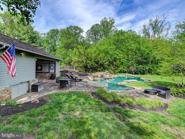 view of green lawn with a patio area and a jacuzzi