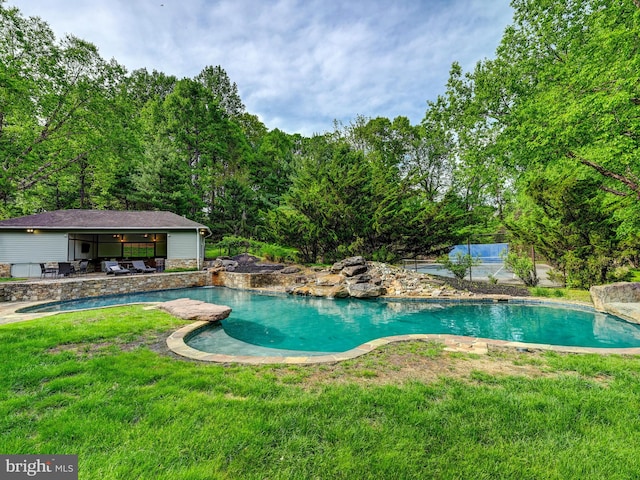 outdoor pool featuring a yard and a patio