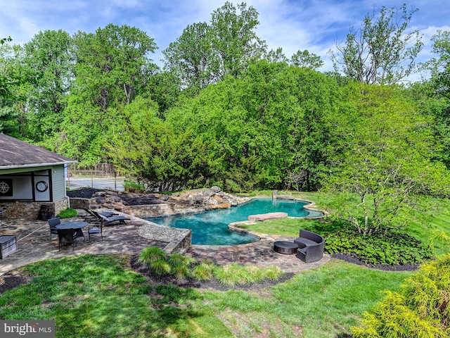 swimming pool featuring a patio area