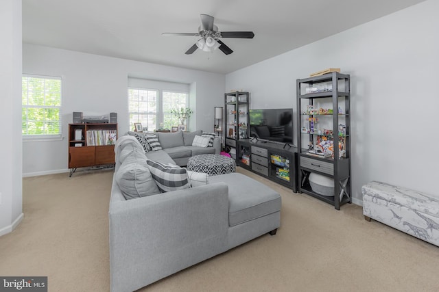 living area with plenty of natural light, carpet, and baseboards