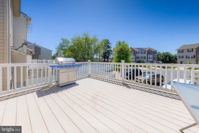 wooden deck with a residential view and grilling area