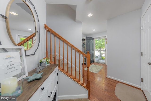 stairway featuring recessed lighting and wood finished floors
