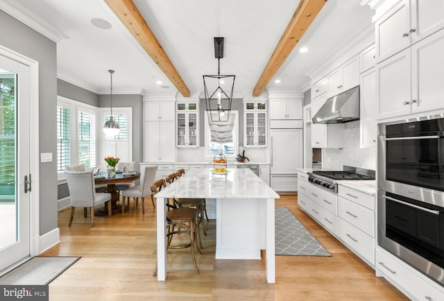 4416 Stanford St, Chevy Chase, MD 20815 - kitchen with white cabinets, stainless steel appliances, decorative backsplash, under cabinet range hood, and glass insert cabinets